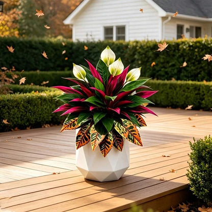 Autumn-themed garden arrangement featuring artificial peace lilies, red dracaena, and orange croton